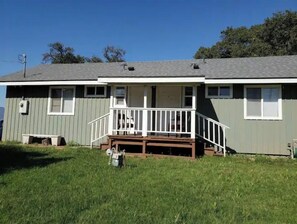 Guests can enjoy a quiet retreat on the front porch with a bench and mailbox.