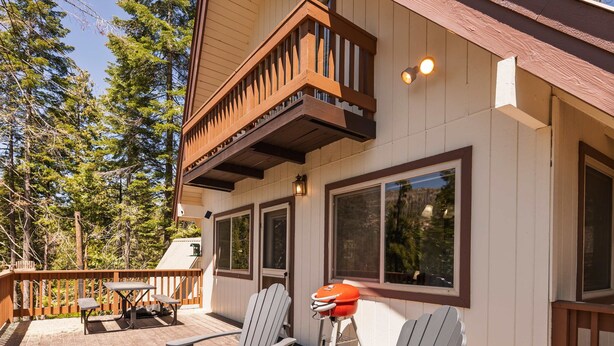 A wooden deck with Adirondack chairs and a barbecue grill. - Cavu Cabin - A Classic Mountainside Escape (Shaver Lake)