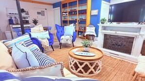 A living room with a sofa, chairs, a coffee table, a fireplace, and a TV. - Lakefront, Swim, Fish, Kayak, fire pit, star gazing, pet friendly. All on site! (New Market)