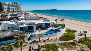 A resort with a pool, beach, and ocean view. - Luxury Oceanfront Home with Pool & Hot Tub - located on Sandy Beach (Puerto Peñasco)