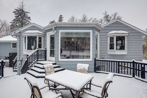 Enjoy a traditional home with a covered outdoor seating area, perfect for relaxing, and a large window offering a view of the surrounding area.