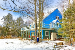 A blue house with a covered porch and a small deck. - Log Cabin Hot tub Private Pool 360 Mountain Views Hunter Mt (Tannersville)