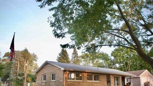 A stone building with a gabled roof and a front porch. - Salisbury (West Lafayette)