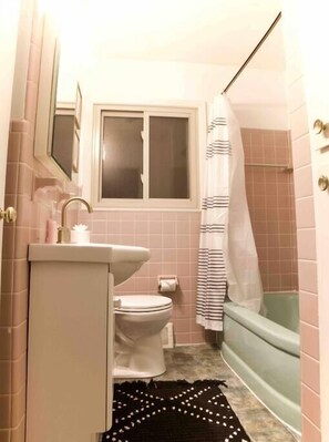 A bathroom with a toilet, sink, and bathtub. - Salisbury (West Lafayette)