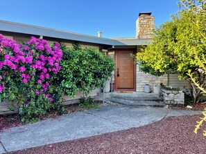 A house with a brown door, a stone chimney, and a concrete driveway. - Newly remodeled Santa Rosa retreat w/ pool and hot tub! (Santa Rosa)