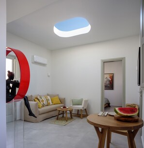 Honeymoon Suite, Hot Tub, Sea View | Living area | 38-inch LCD TV with digital channels, TV - Oia Treasures Art Suites (Santorini)