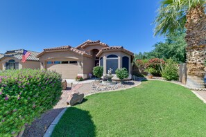 Enjoy the serene surroundings of this property, featuring a well-maintained lawn and a variety of landscaping, including a rock garden and a small fountain.