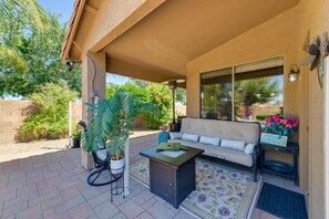 Relax in this inviting outdoor space with a sofa, side table, and potted plant.