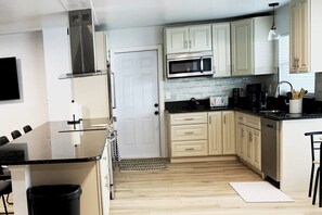 Fridge, microwave, oven, stovetop - This house is a 4 bedroom(s), 3 bathrooms, located in Cape Coral, FL. (Cape Coral)