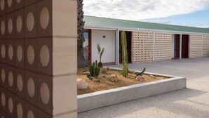 A building with a green roof, a cactus garden, and a patterned wall. - The Monty (Anglesea)