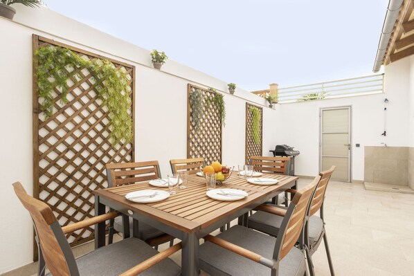 Enjoy a casual meal in this inviting outdoor dining area with a table for four.