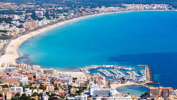 A coastal cityscape with a marina, sandy beaches, and dense urban buildings. - 3 bedroom house near the sea (Can Picafort)