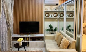 Deluxe Condo | Living area | TV, fireplace