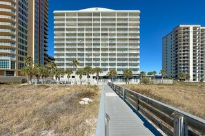 Experience the contemporary architecture of this beachfront hotel, featuring a multi-story structure with balconies and a flat roof.