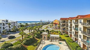 A resort with a swimming pool, multiple-story buildings, and a view of the ocean. - 🌊Beautiful Peek of the Gulf~Pools~Walk2Beach~On the Beach🌊 (Miramar Beach)