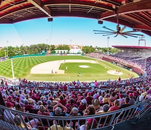 A baseball stadium with a large seating area and a central field.