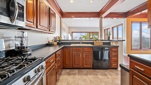 A modern kitchen with wooden cabinets, a stainless steel stove, and a dishwasher. - Beautiful Hillside Home with Incredible City Views!! Great Location and Privacy! (Pittsburgh)