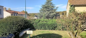 Experience a tranquil retreat in a beautifully maintained garden surrounded by traditional European-style buildings.