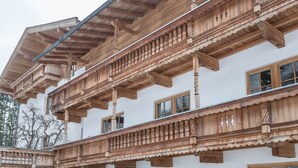 A multi-story building with wooden balconies and a traditional architectural style. - Krafttal Kelchsau – Where New Energy Awaits (Kelchsau)