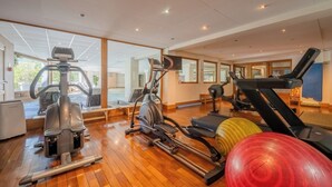 A gym with exercise equipment, large windows, and a wooden floor. - V Buet 53: Beside Ski Lift; Pool, Sauna & Gym, Vallorcine (Argentiere), France (Vallorcine (Argentiere))