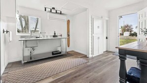 A modern kitchen with a large window, a built-in oven, and a sink. - Orange Blossom Cottage Near Sequoias w/EV Charger (Exeter)