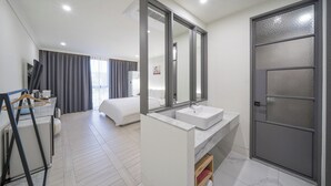 A modern hotel room with a large bed, a bathroom with a marble sink, and a sliding door. - Hotel PIED Suseong (Daegu)