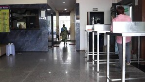 A hotel lobby with a reception desk, a menu board, and a person walking towards the exit. - Hotel Bablu Yadav (Maheshwaram)