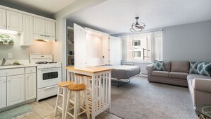 A compact living space with a kitchenette, a dining area, and a sofa. - 1st floor Studio Condo:  Walk right out to an amazing pool and beach (South Haven)