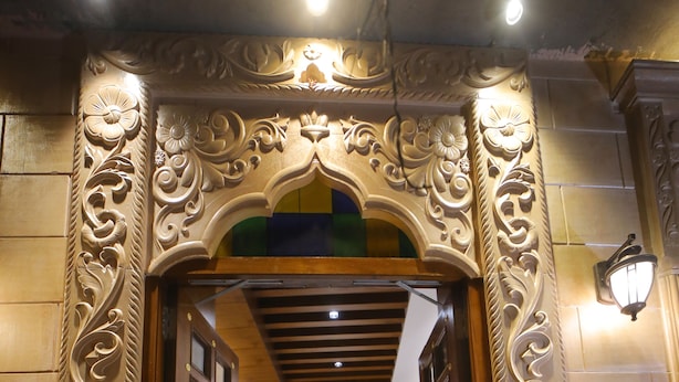 An ornate hotel entrance with a grand staircase leading to a reception area. - The Sky Imperial Hotel Sugam (Nathdwara)