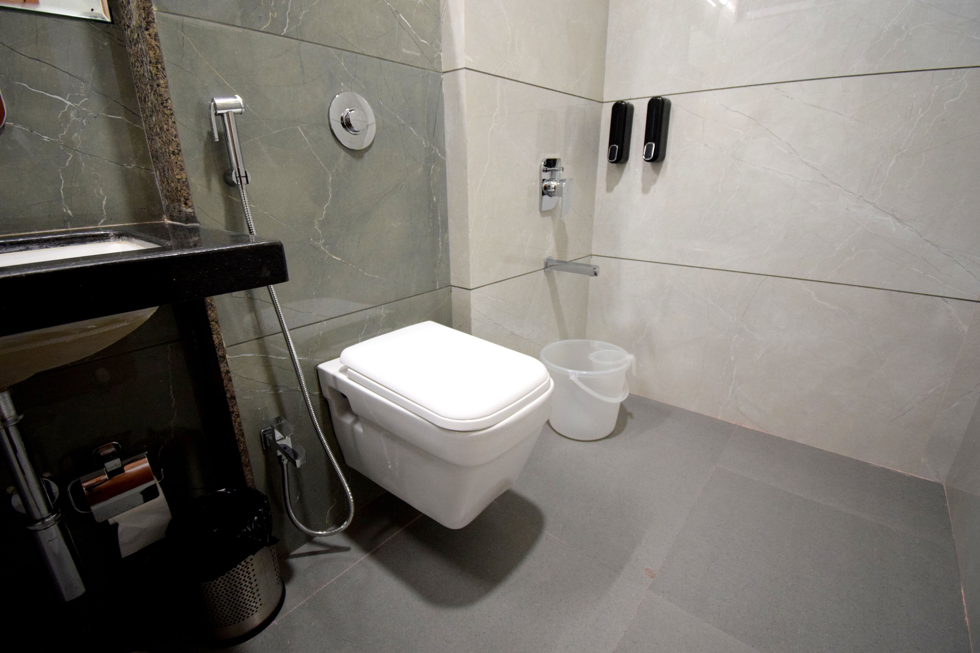 A modern bathroom with a toilet, sink, and shower.