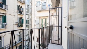 A multi-story residential building with balconies, a gated entrance, and a visible door. - Poerio 98 Luxury Apartment (Naples)