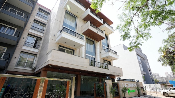 A multi-story residential building with balconies, a gated entrance, and potted plants. - Udman by Ferns N Petals Gurugram (Gurugram)