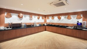 A modern kitchen with wooden cabinets, a marble backsplash, and a herringbone floor pattern. - Udman by Ferns N Petals Gurugram (Gurugram)