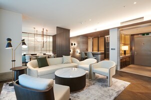 Prestige Suite | Living area | 50-inch flat-screen TV with cable channels, TV