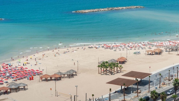 A beach with umbrellas and beach huts. - Country side 3cabin complex & HeatedPool (Galil Tachton)