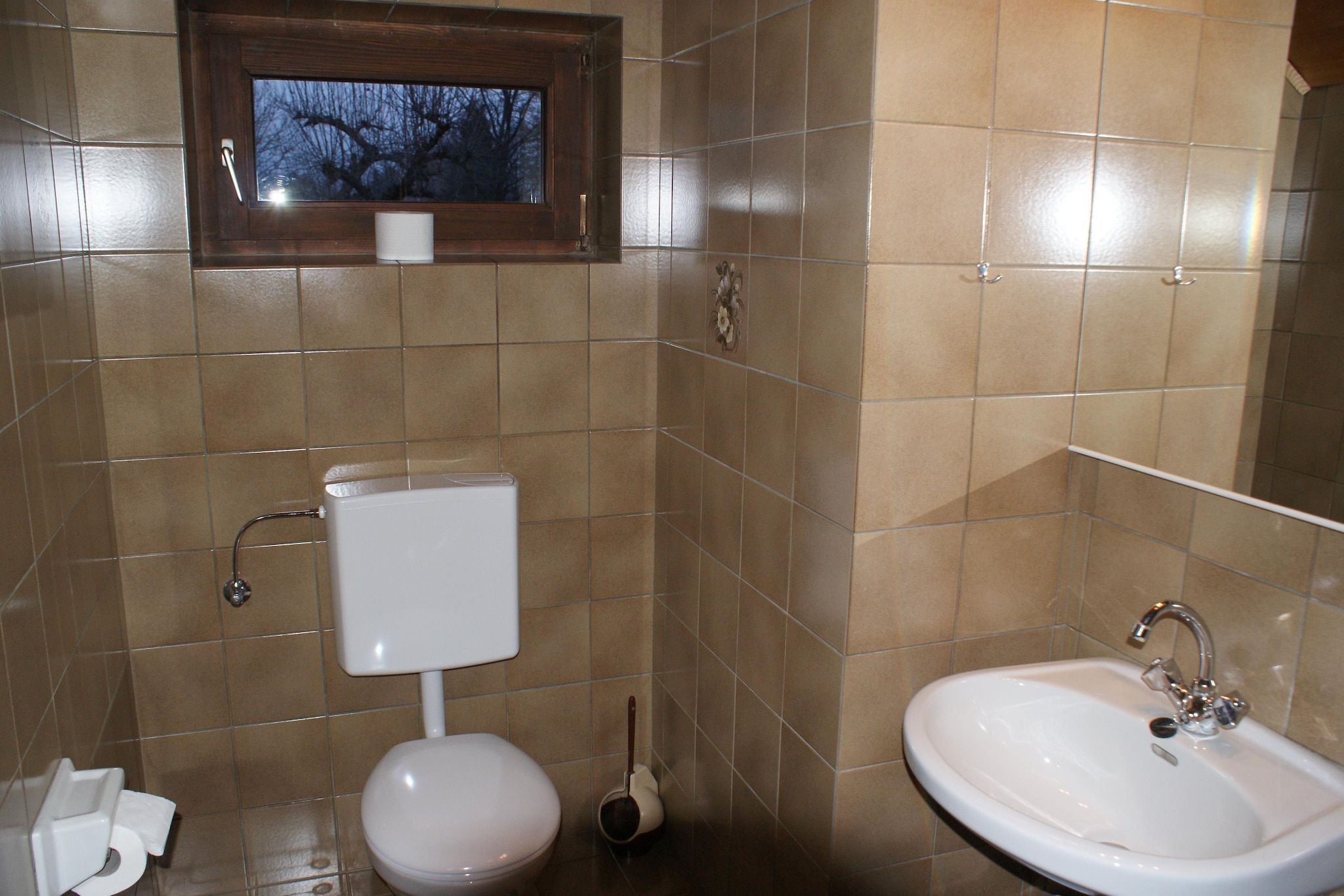 A bathroom with a toilet, a bidet, and a sink.