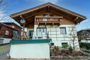 A two-story building with a wooden facade, a balcony, and a small garden area. - Chalet in Kaltenbach near Ski Lift (Kaltenbach)
