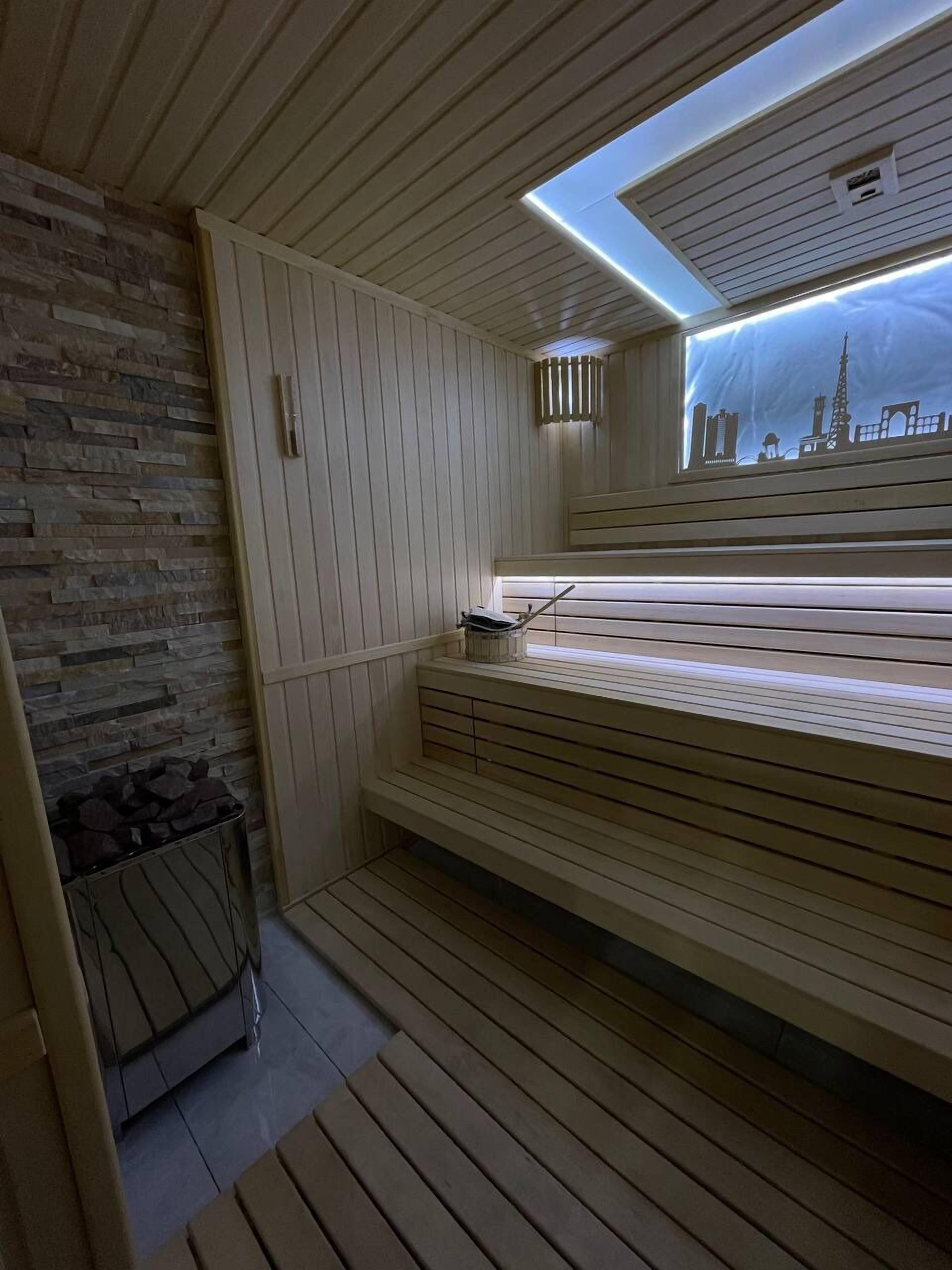 A sauna with wooden benches and a skylight.