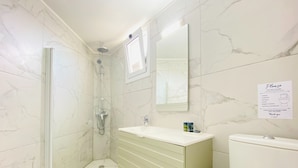 A bathroom with a shower, toilet, and sink. - Phaedrus Living Luxury Flat Lighthouse75 (Paphos)