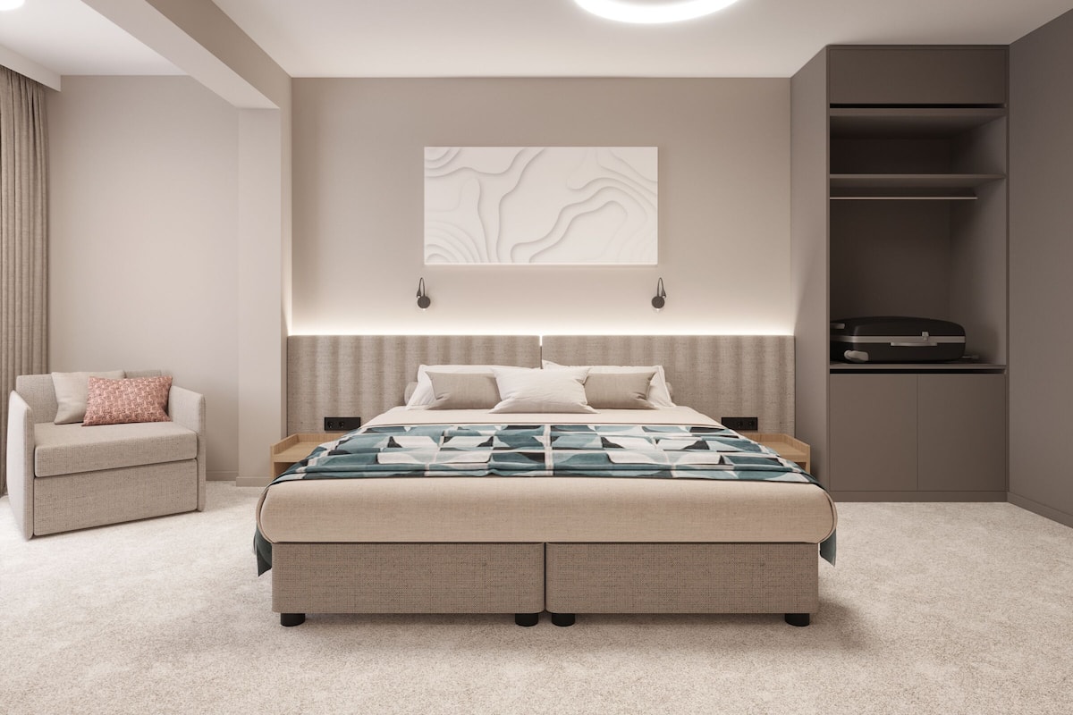 Un dormitorio moderno con una cama grande, una mesita de noche, una silla, un armario y una obra de arte colgada en la pared.