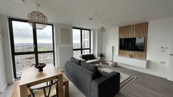 Apartment | Living area | 30-inch TV with cable channels