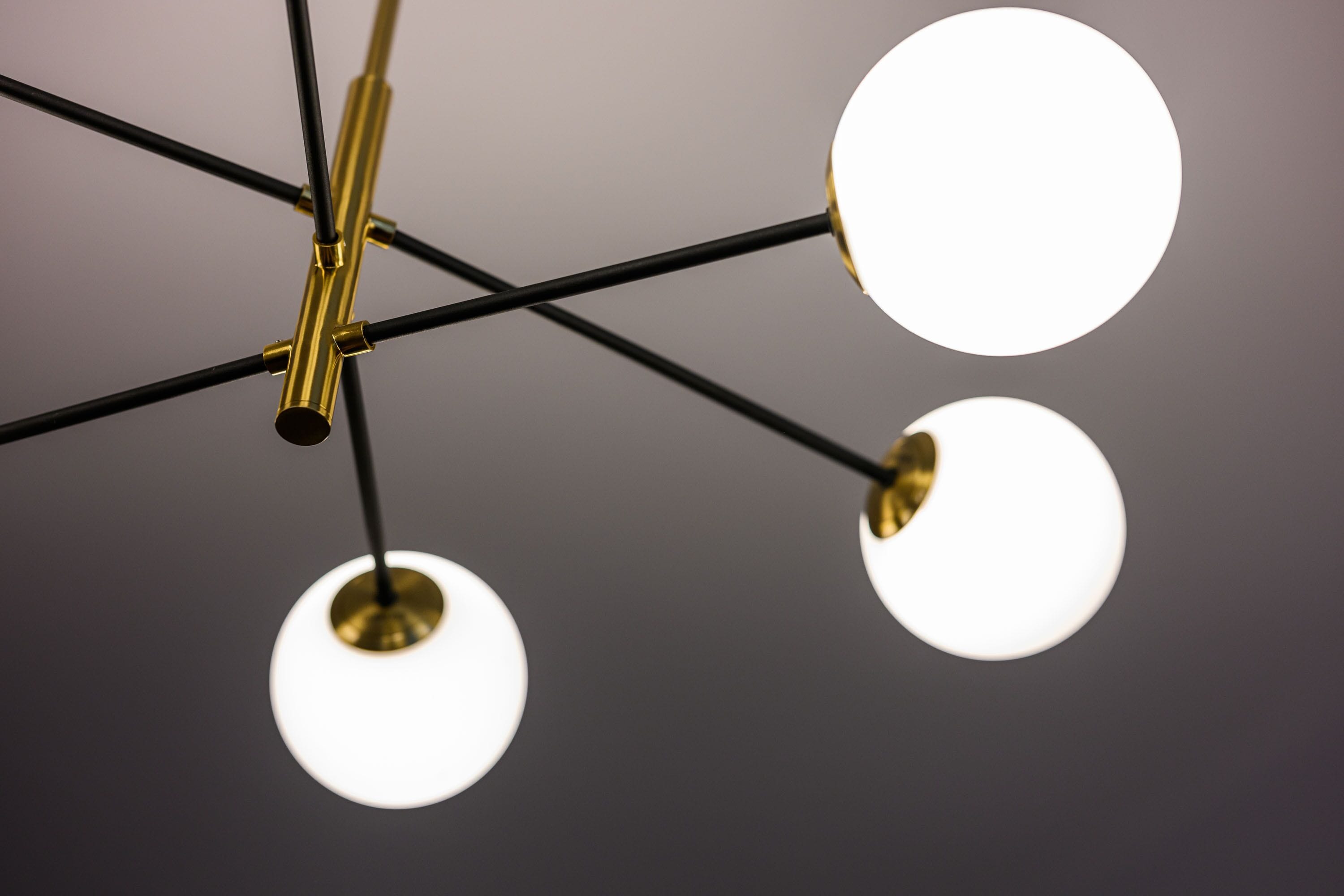 A ceiling with a modern chandelier featuring multiple spherical light fixtures.