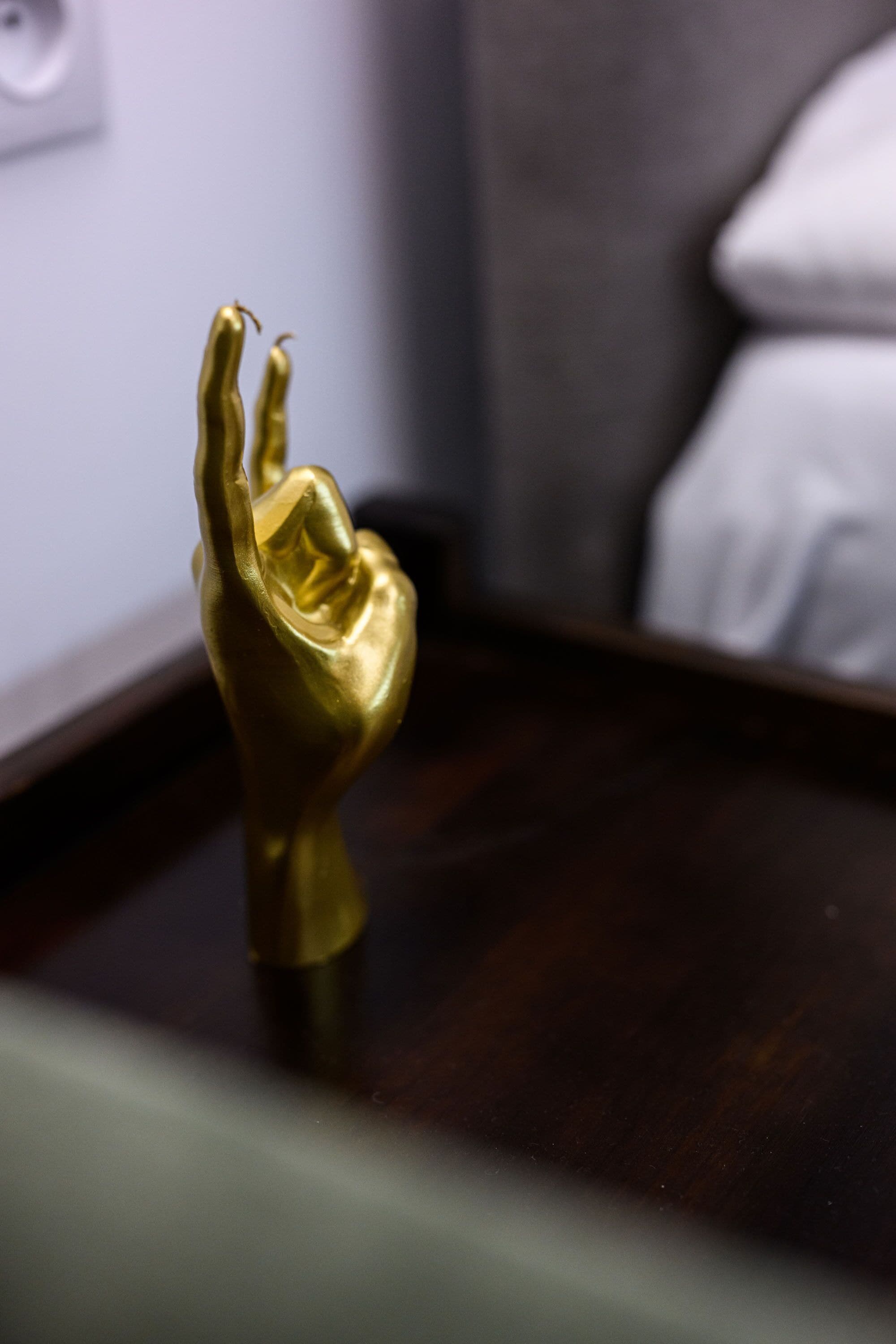 A golden statue on a wooden surface.