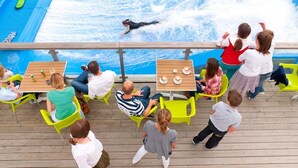 A pool area with people watching a performer. - Waveside-Waterside with hot tub,Resort Pool/Gym (Winnard's Perch)