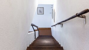 A staircase with wooden steps and white walls.