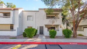 A two-story residential building with a flat roof, a front entrance, and a small balcony. - Walkable 2BR in Old Town w/ Pool + More (Scottsdale)