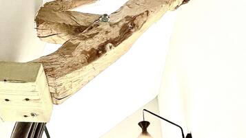 Una escultura de madera con una lámpara en una habitación.
