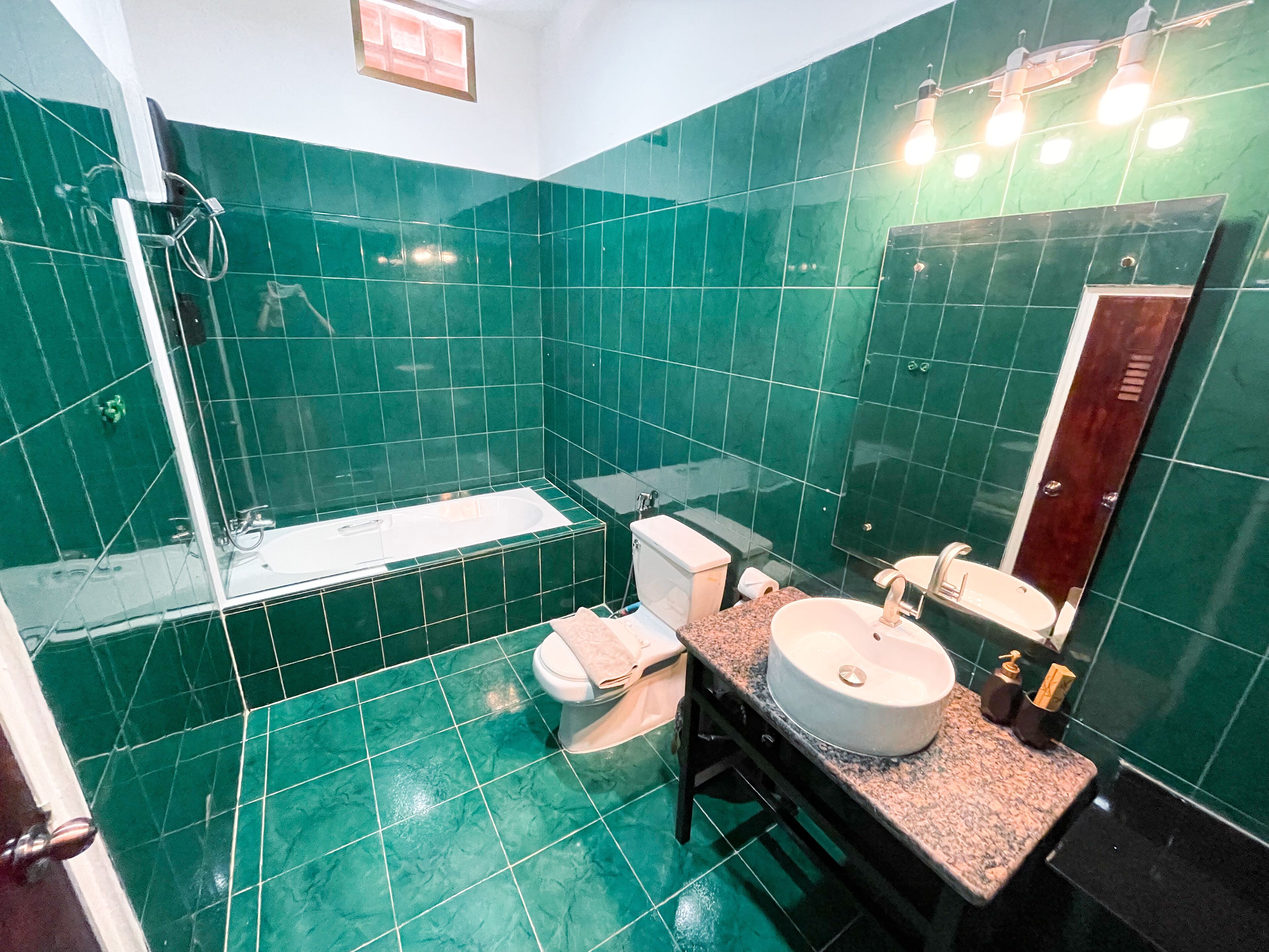 A bathroom with a bathtub, toilet, sink, and shower.