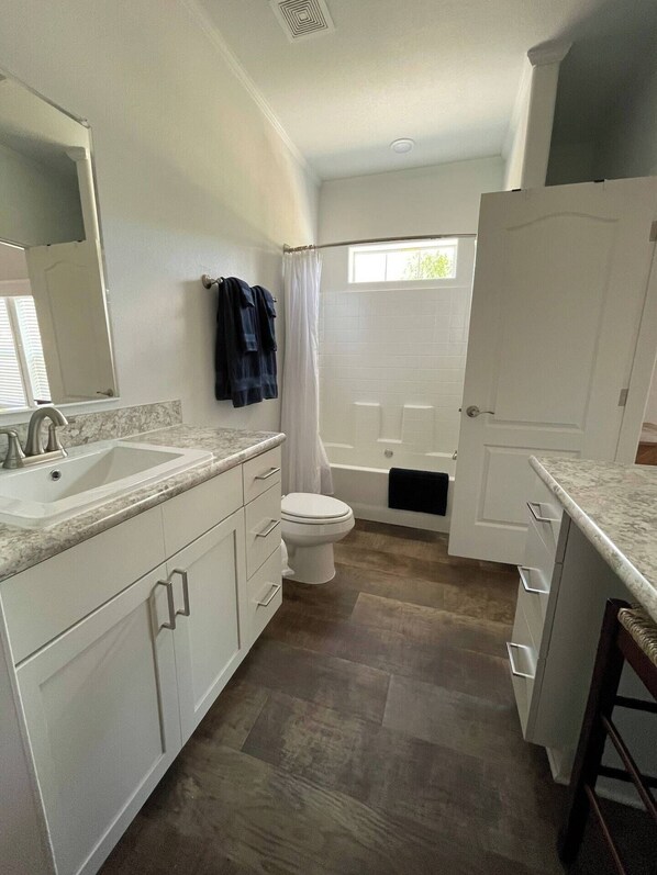 A modern bathroom with a sink, toilet, and bathtub. - 2Bed/2Bath with Creek and Open Spaces (Durango)