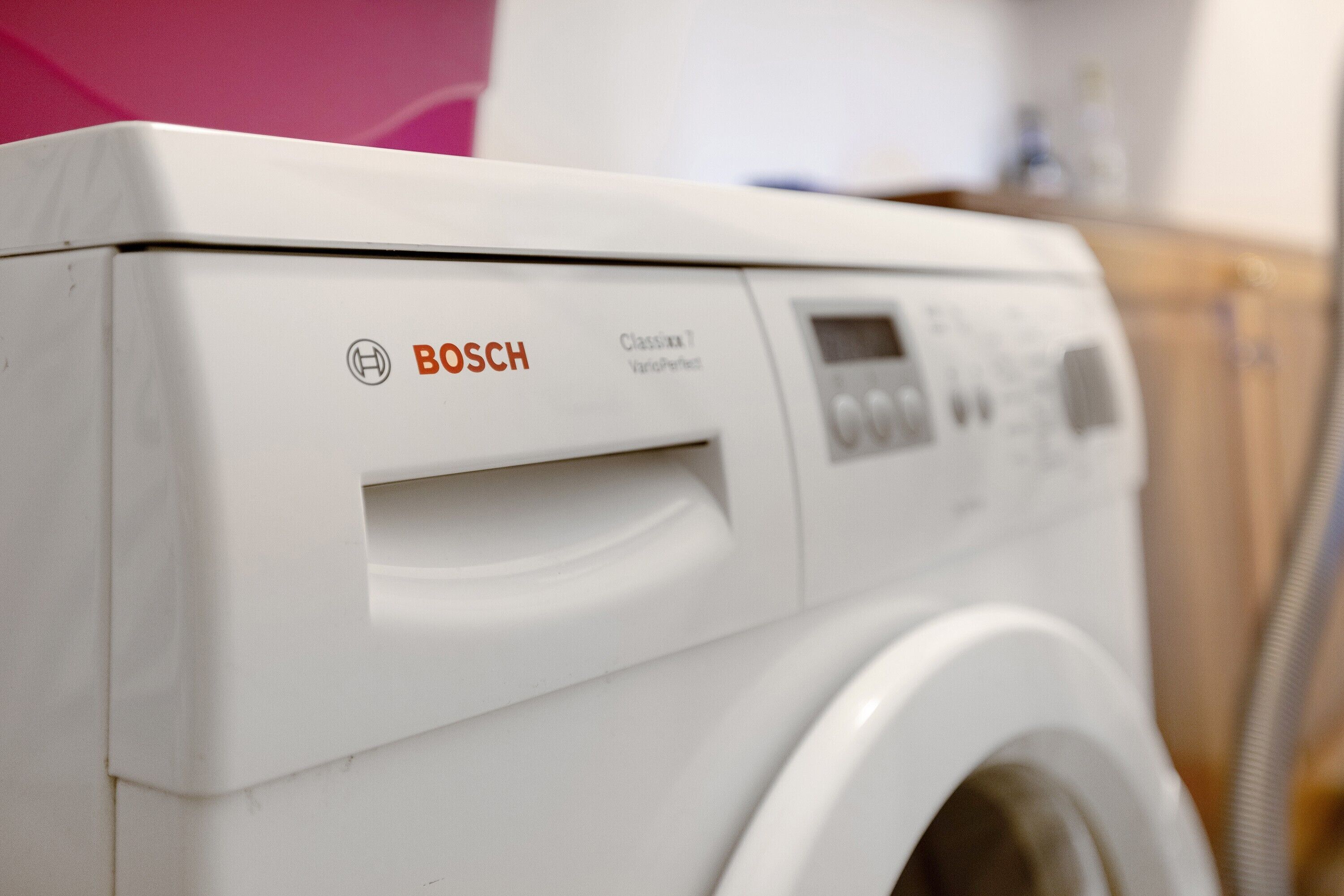 A white Bosch washing machine with a control panel and a front-loading door.